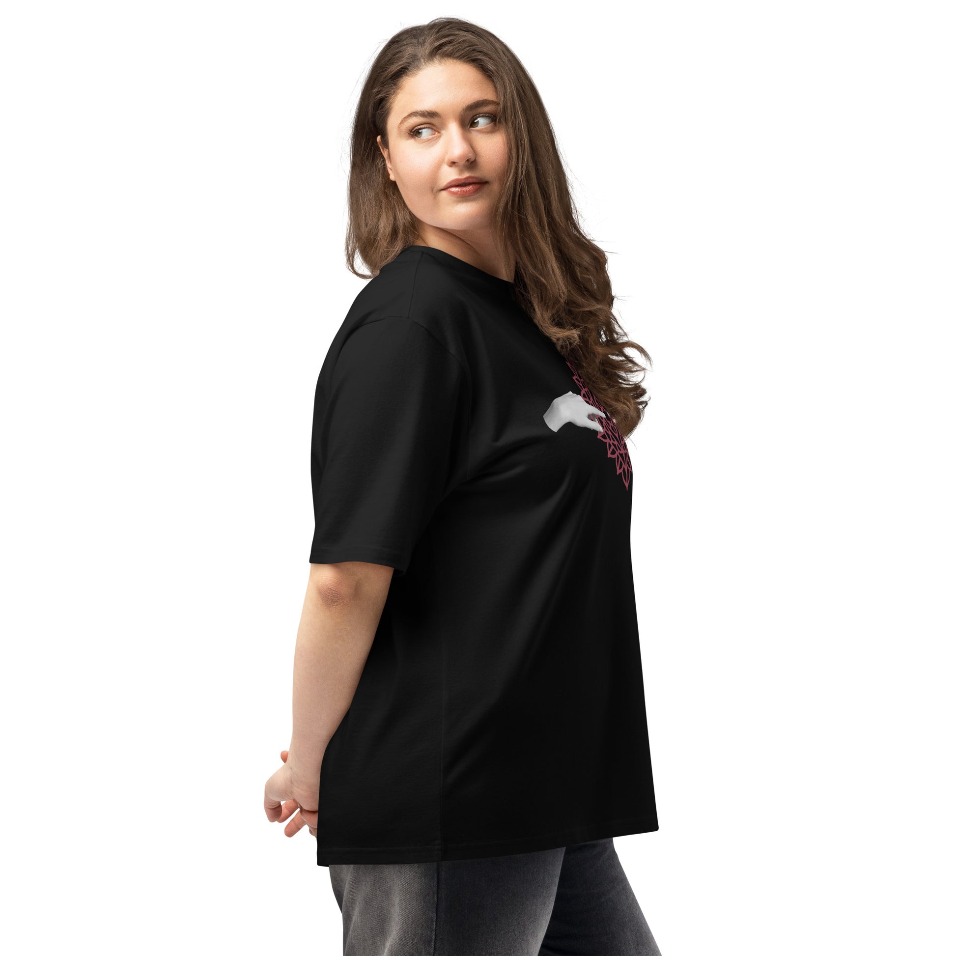 A woman standing in a black t-shirt.